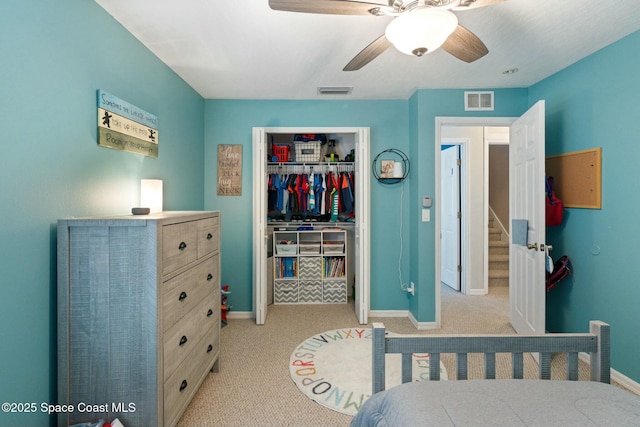 bedroom featuring light carpet, a closet, and ceiling fan