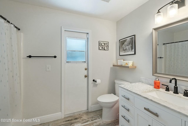 bathroom with a shower with shower curtain, vanity, wood-type flooring, and toilet