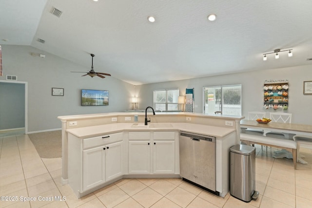 kitchen featuring stainless steel dishwasher, white cabinets, sink, and an island with sink