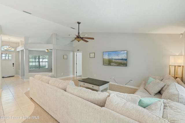 living room with ceiling fan, light tile patterned floors, and vaulted ceiling