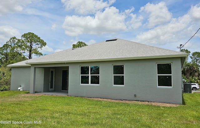 rear view of property featuring a patio area and a lawn