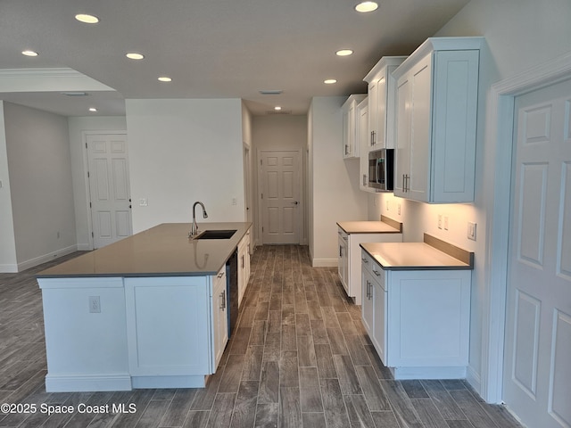 kitchen with dishwasher, a center island with sink, electric range, sink, and white cabinets