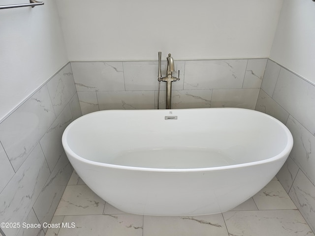 bathroom with tile walls and a bath