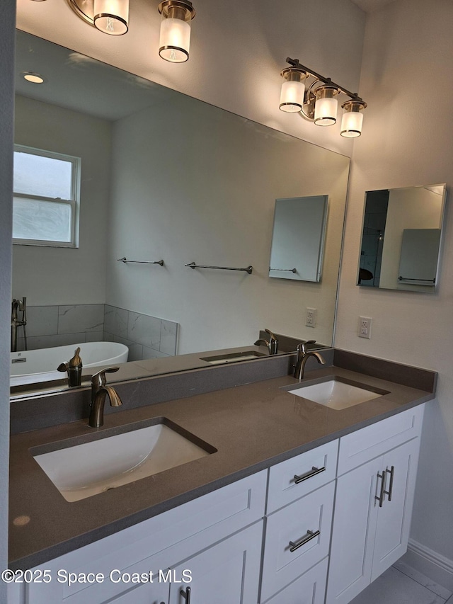 bathroom with a tub to relax in and vanity