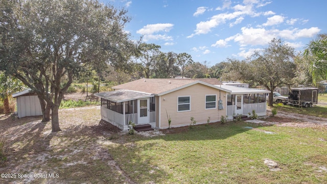 back of house featuring a sunroom and a yard