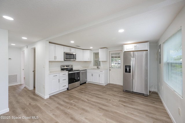 kitchen with white cabinetry, sink, and appliances with stainless steel finishes