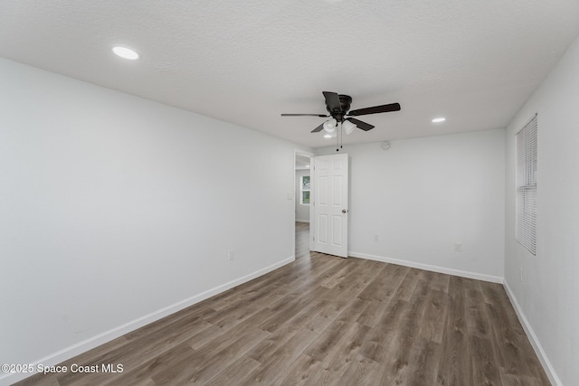 spare room featuring a textured ceiling, hardwood / wood-style flooring, and ceiling fan