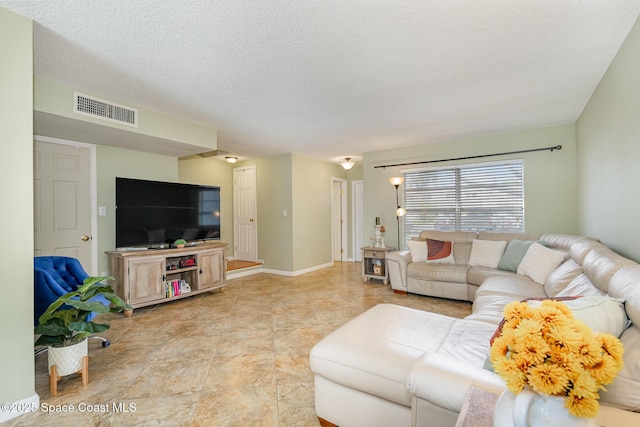 living room with light tile patterned floors and a textured ceiling