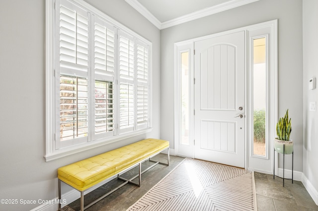 foyer entrance with dark tile patterned flooring, plenty of natural light, and ornamental molding