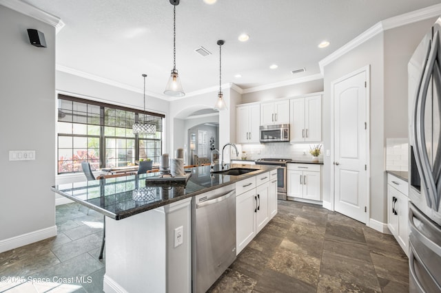 kitchen featuring sink, white cabinetry, a kitchen island with sink, and appliances with stainless steel finishes