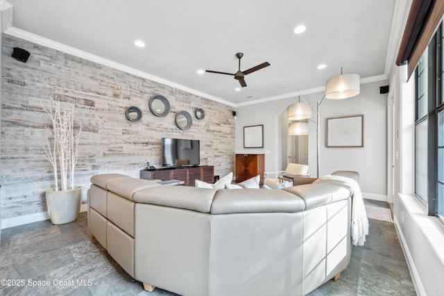 living room with ceiling fan and ornamental molding