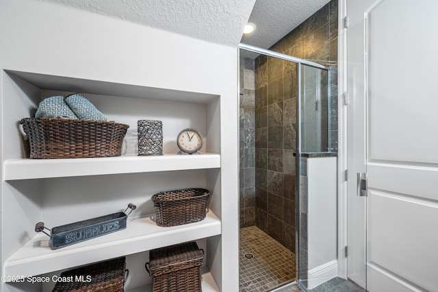 bathroom featuring a textured ceiling and walk in shower