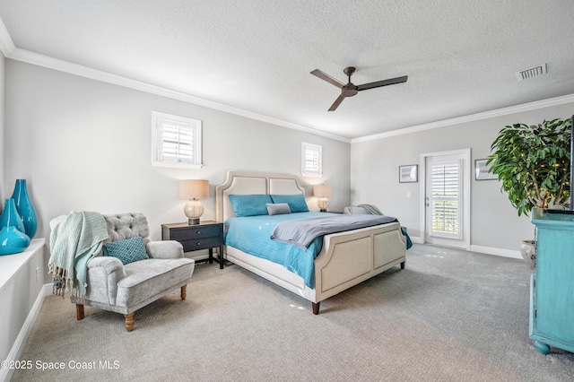 bedroom with carpet, ceiling fan, ornamental molding, and a textured ceiling