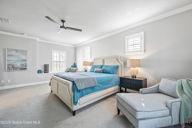 bedroom featuring ceiling fan, carpet, a textured ceiling, and ornamental molding