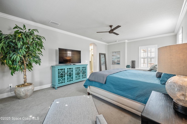 bedroom with a textured ceiling, ceiling fan, crown molding, and light carpet