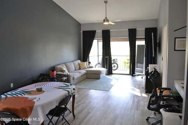 living room with light hardwood / wood-style floors and ceiling fan