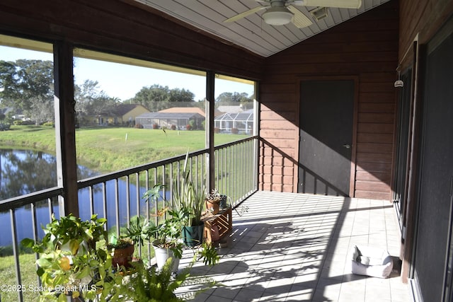 balcony featuring ceiling fan and a water view