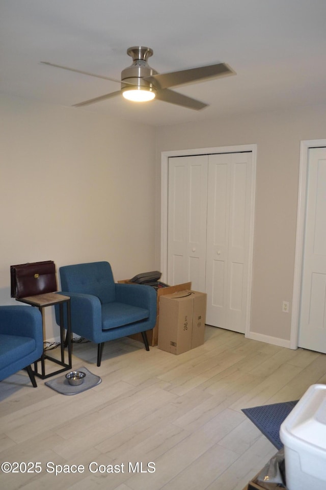 sitting room featuring ceiling fan and light hardwood / wood-style flooring