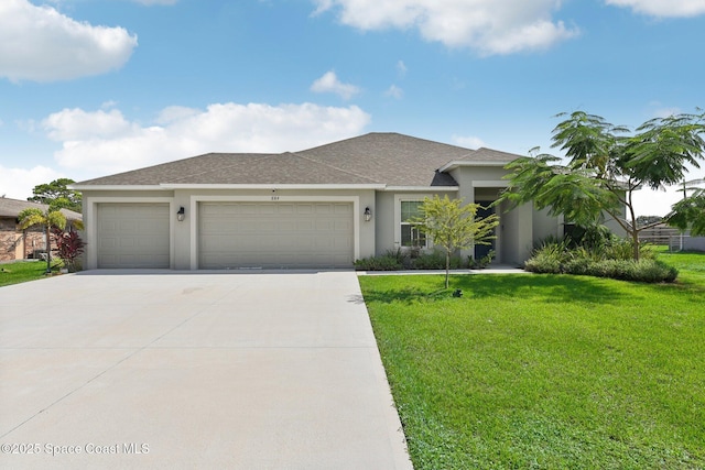 view of front of home featuring a front lawn and a garage