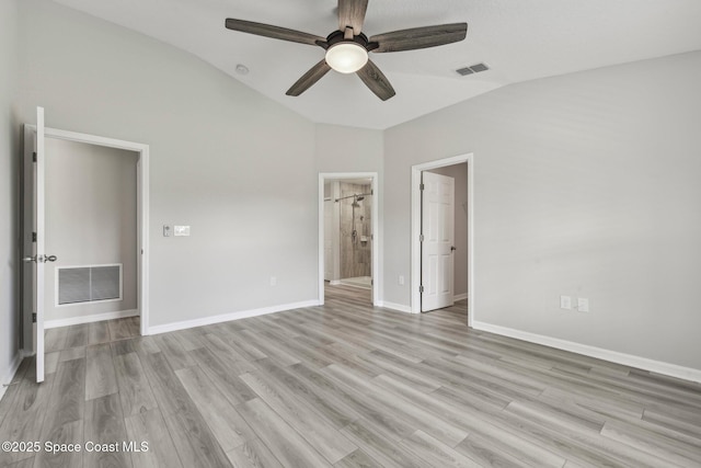 unfurnished bedroom with connected bathroom, ceiling fan, light hardwood / wood-style flooring, and lofted ceiling