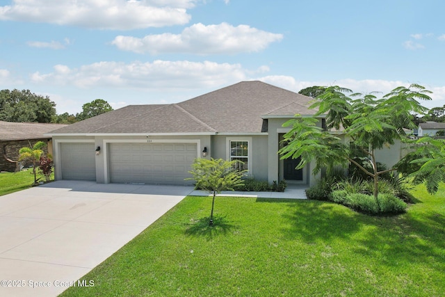 view of front of home with a front lawn and a garage