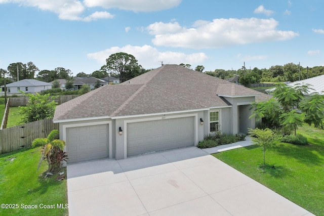 ranch-style house featuring a garage and a front lawn