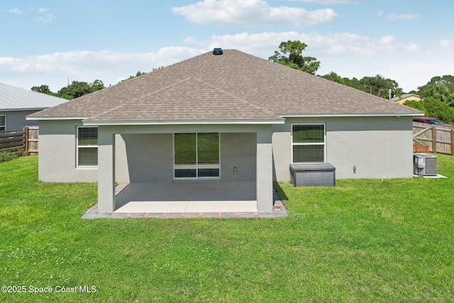 rear view of house with a lawn, a patio area, and central AC unit