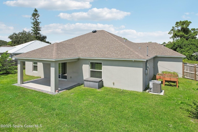 rear view of house featuring a patio, central AC unit, and a lawn