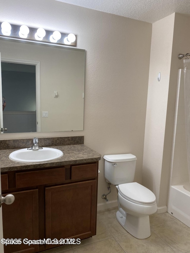 full bathroom with washtub / shower combination, tile patterned flooring, a textured ceiling, toilet, and vanity