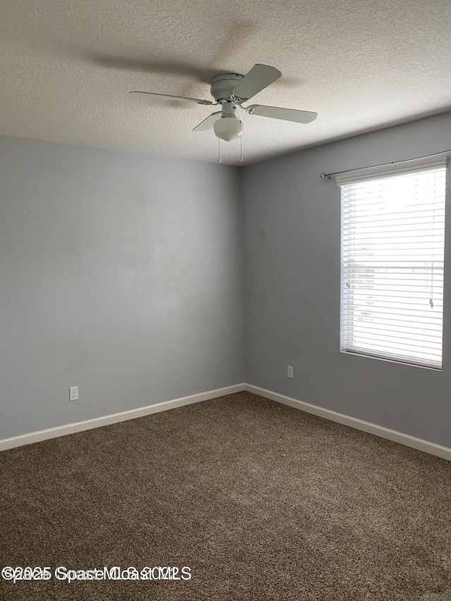 unfurnished room with carpet flooring, ceiling fan, and a textured ceiling