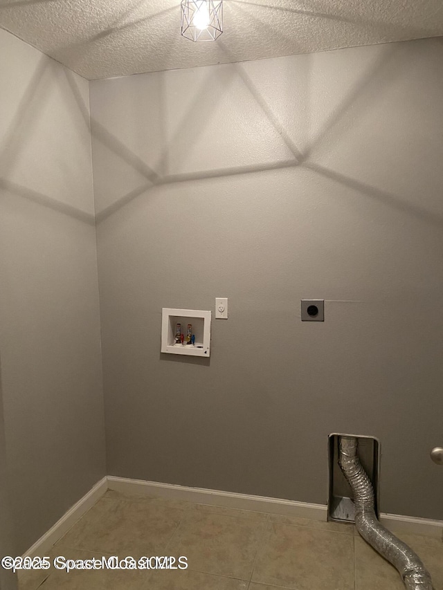 clothes washing area featuring washer hookup, a textured ceiling, tile patterned floors, and electric dryer hookup