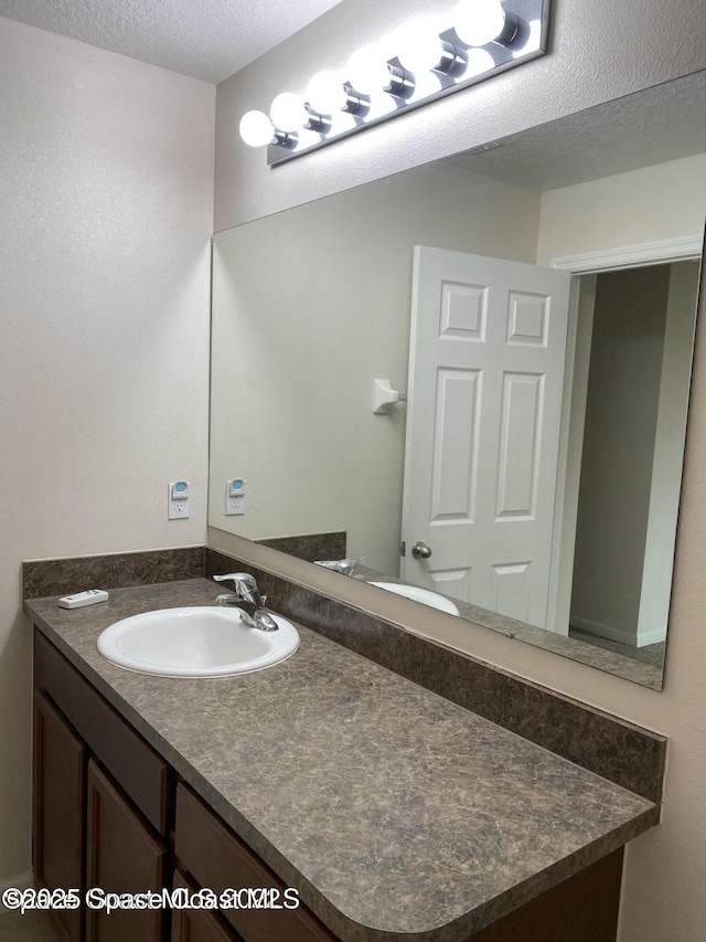 bathroom featuring vanity and a textured ceiling