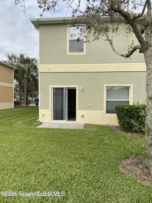 rear view of house with a yard