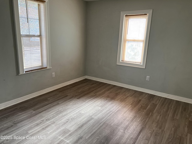 empty room with dark wood-type flooring