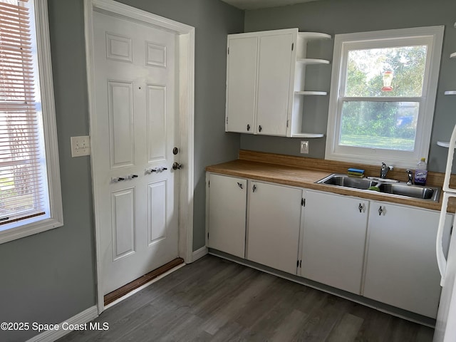 kitchen with white cabinets, a wealth of natural light, and sink