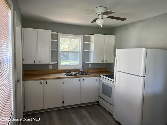 kitchen with white appliances, sink, dark hardwood / wood-style floors, ceiling fan, and white cabinetry