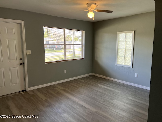 empty room with ceiling fan and wood-type flooring