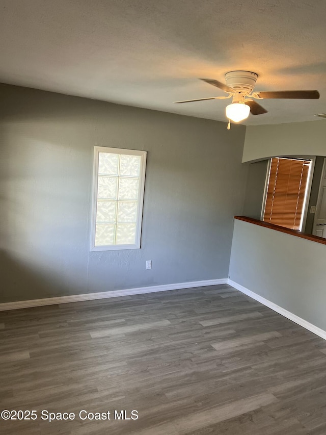 empty room with ceiling fan and wood-type flooring