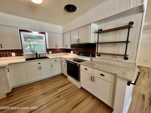 kitchen with white cabinets, white range with electric stovetop, and sink