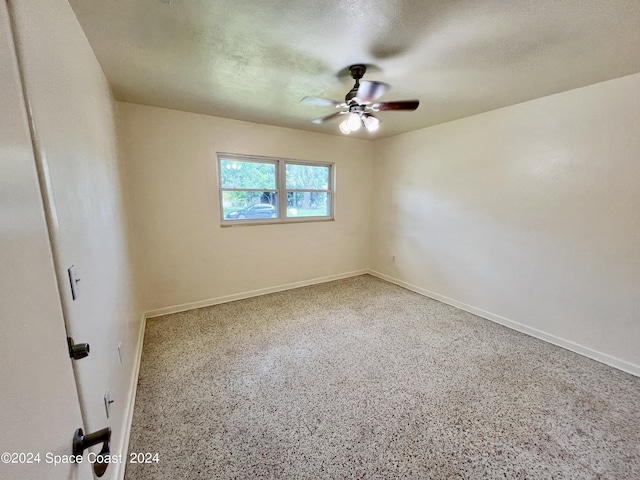 spare room featuring ceiling fan and a textured ceiling