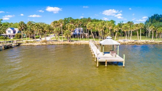 view of dock with a gazebo and a water view