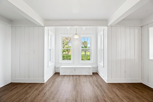 interior space with dark hardwood / wood-style flooring, ornamental molding, and an inviting chandelier