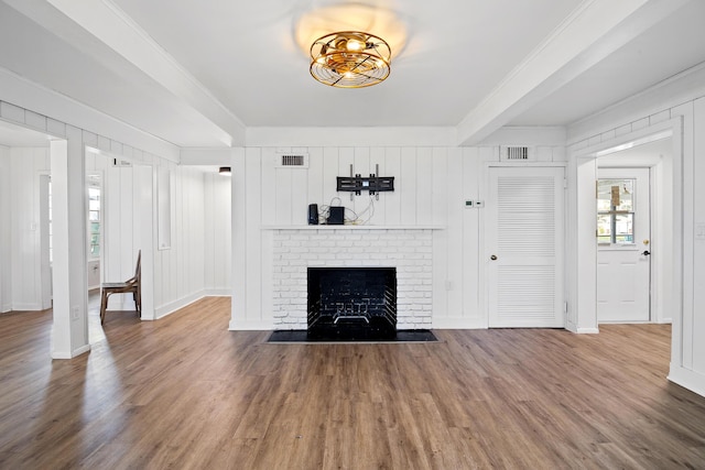 unfurnished living room with a fireplace, plenty of natural light, and hardwood / wood-style floors