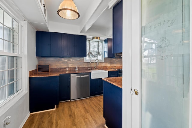 kitchen with blue cabinetry, sink, light hardwood / wood-style flooring, stainless steel dishwasher, and decorative backsplash