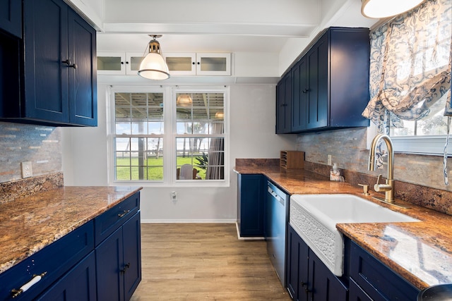 kitchen with stainless steel dishwasher, blue cabinets, and sink