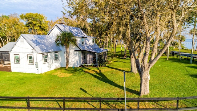 view of home's exterior with a lawn and a trampoline