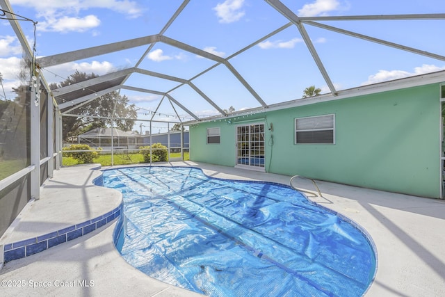 view of pool featuring a patio and glass enclosure