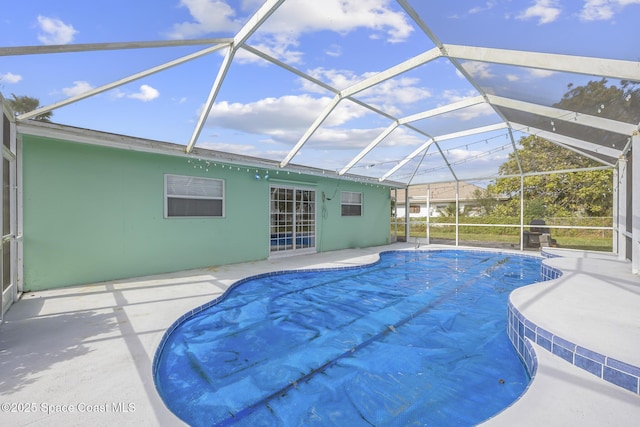 view of pool featuring a patio and glass enclosure