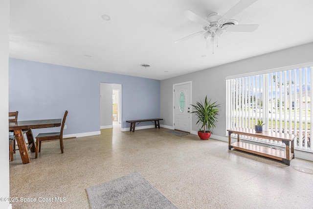 interior space with ceiling fan