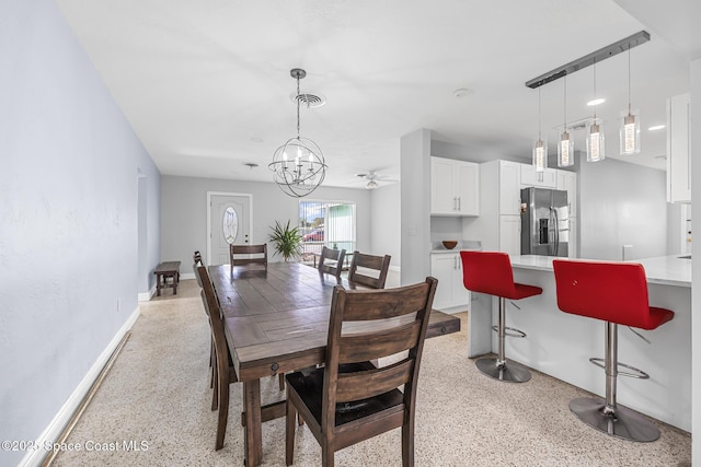 dining room featuring ceiling fan with notable chandelier